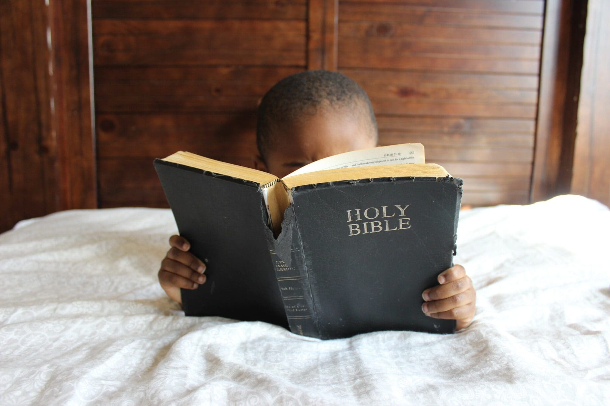 Photo of Kid Reading a Bible